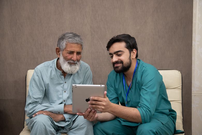 caregiver taking care of  elderly patient